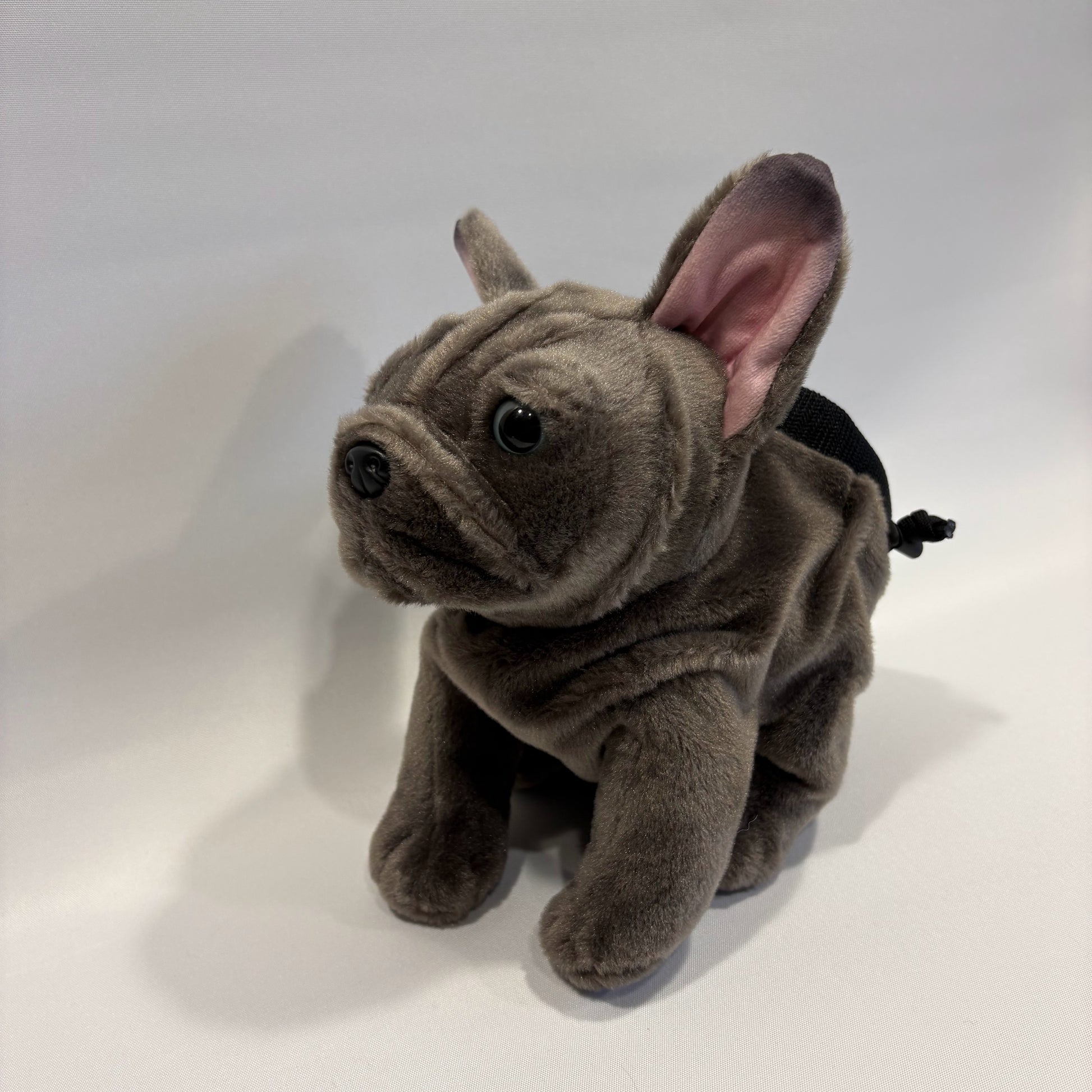 Grey boxer dog plush rock climbing chalk bag, showcasing unique climbing gear, on a white background