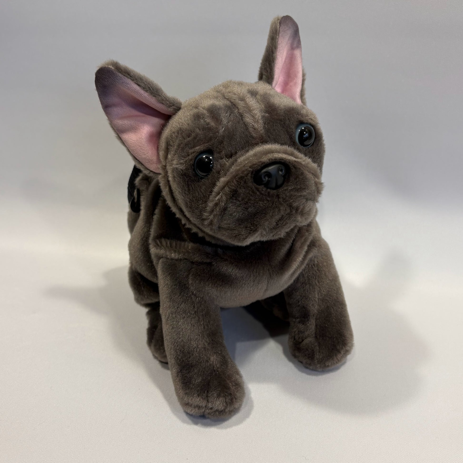 Grey boxer dog plush rock climbing chalk bag, showcasing unique climbing gear, on a white background