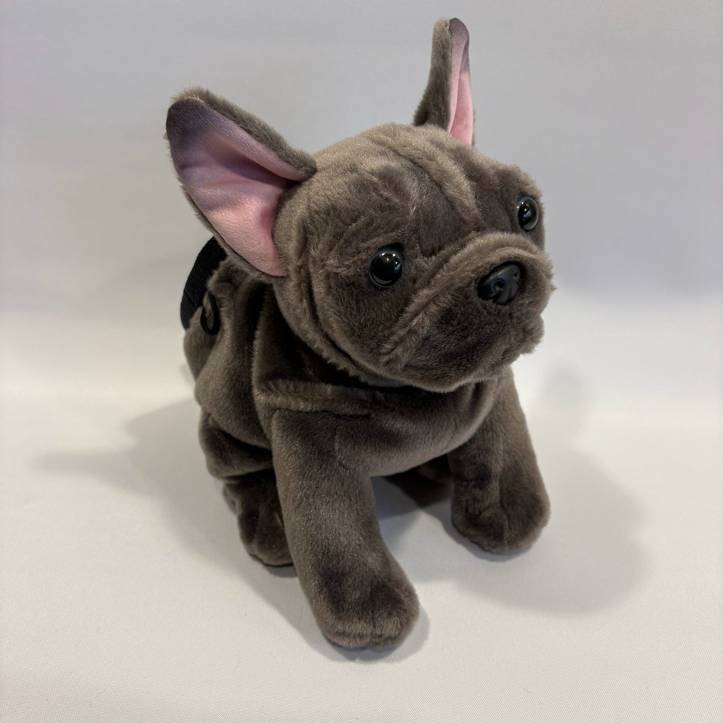 Grey boxer dog plush rock climbing chalk bag, showcasing unique climbing gear, on a white background