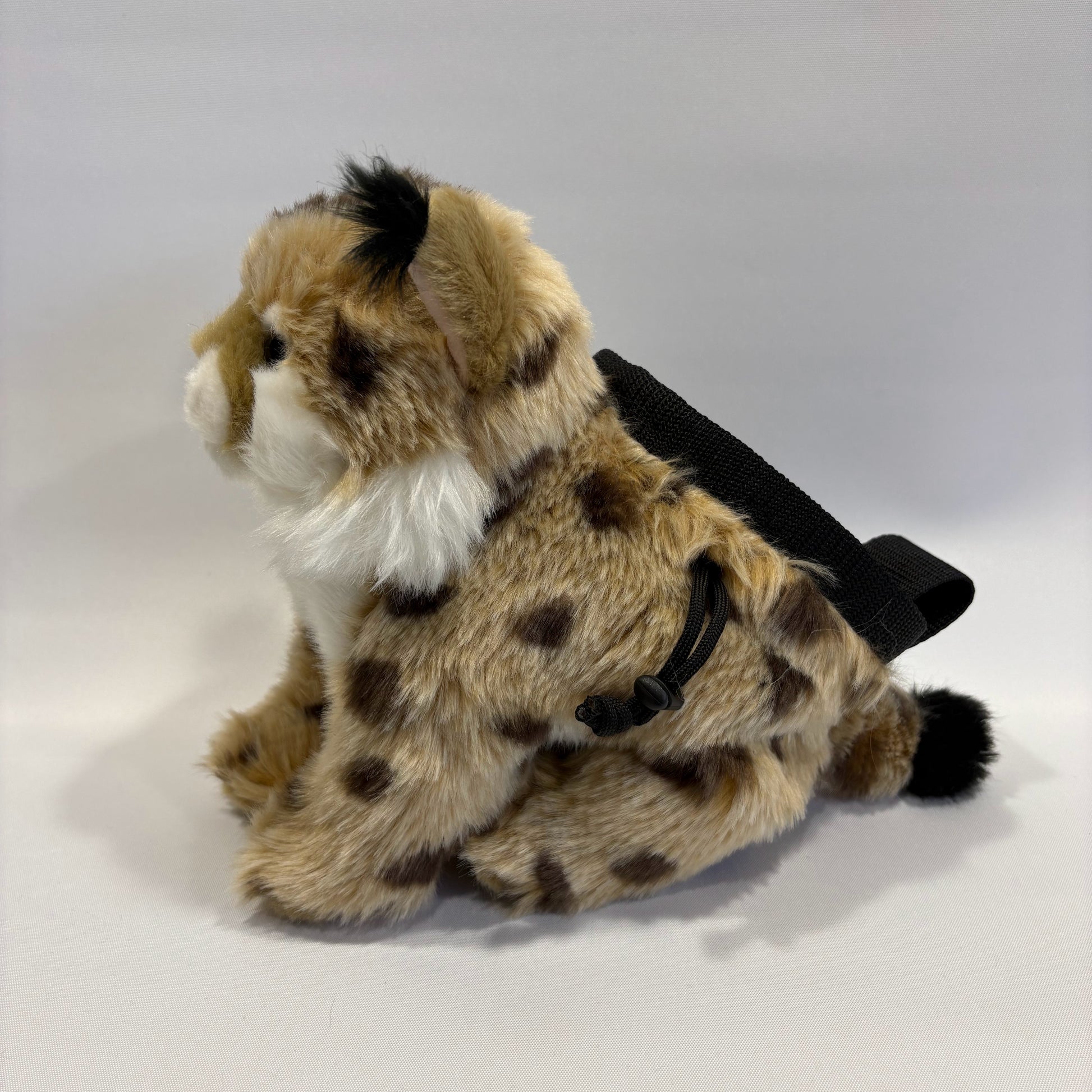 Bobcat plush rock climbing chalk bag shown side on, showing unique climbing gear for kids and women. Background is white