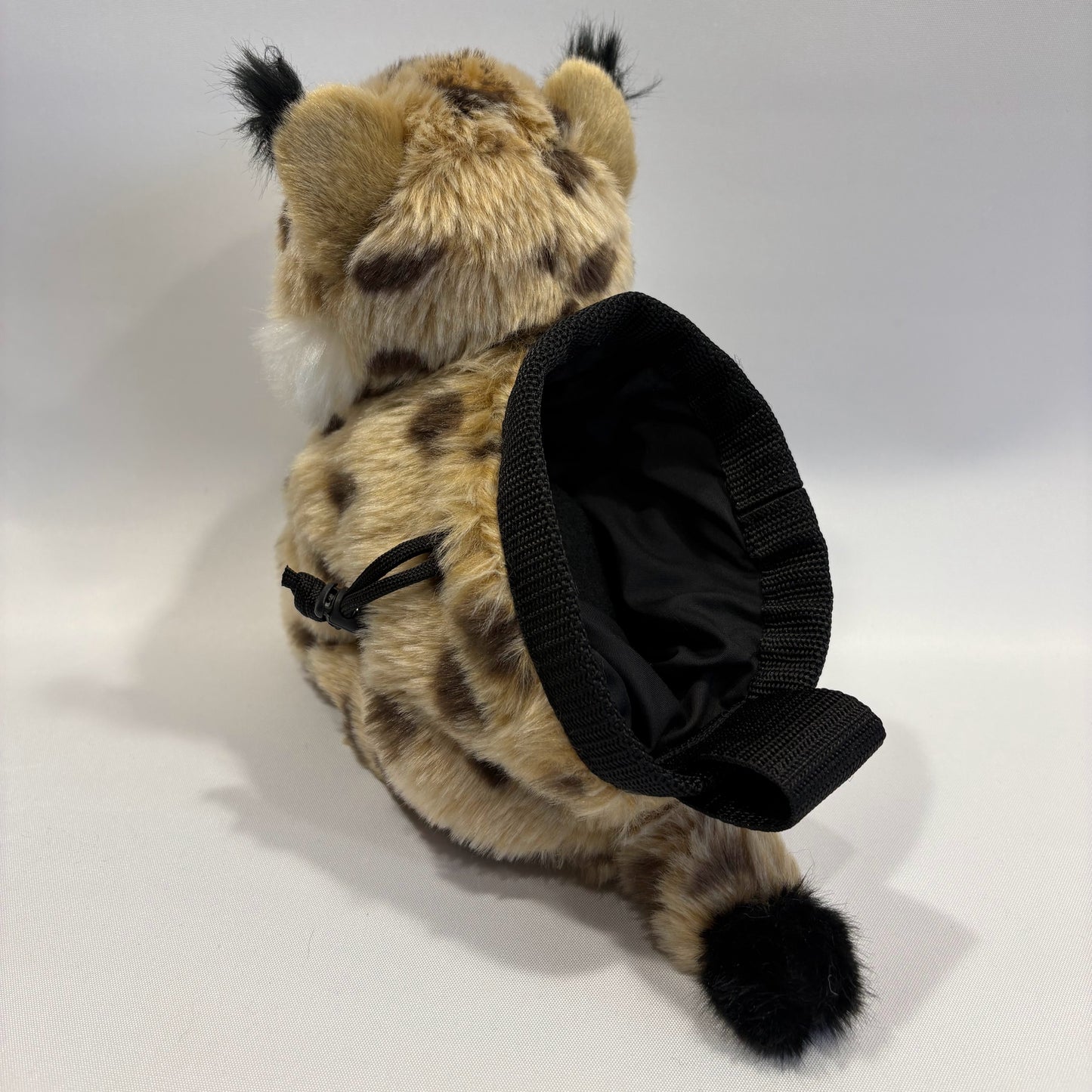 Bobcat plush rock climbing chalk bag rear view showing chalk bag section. Unique climbing gear for kids and women. Background is white