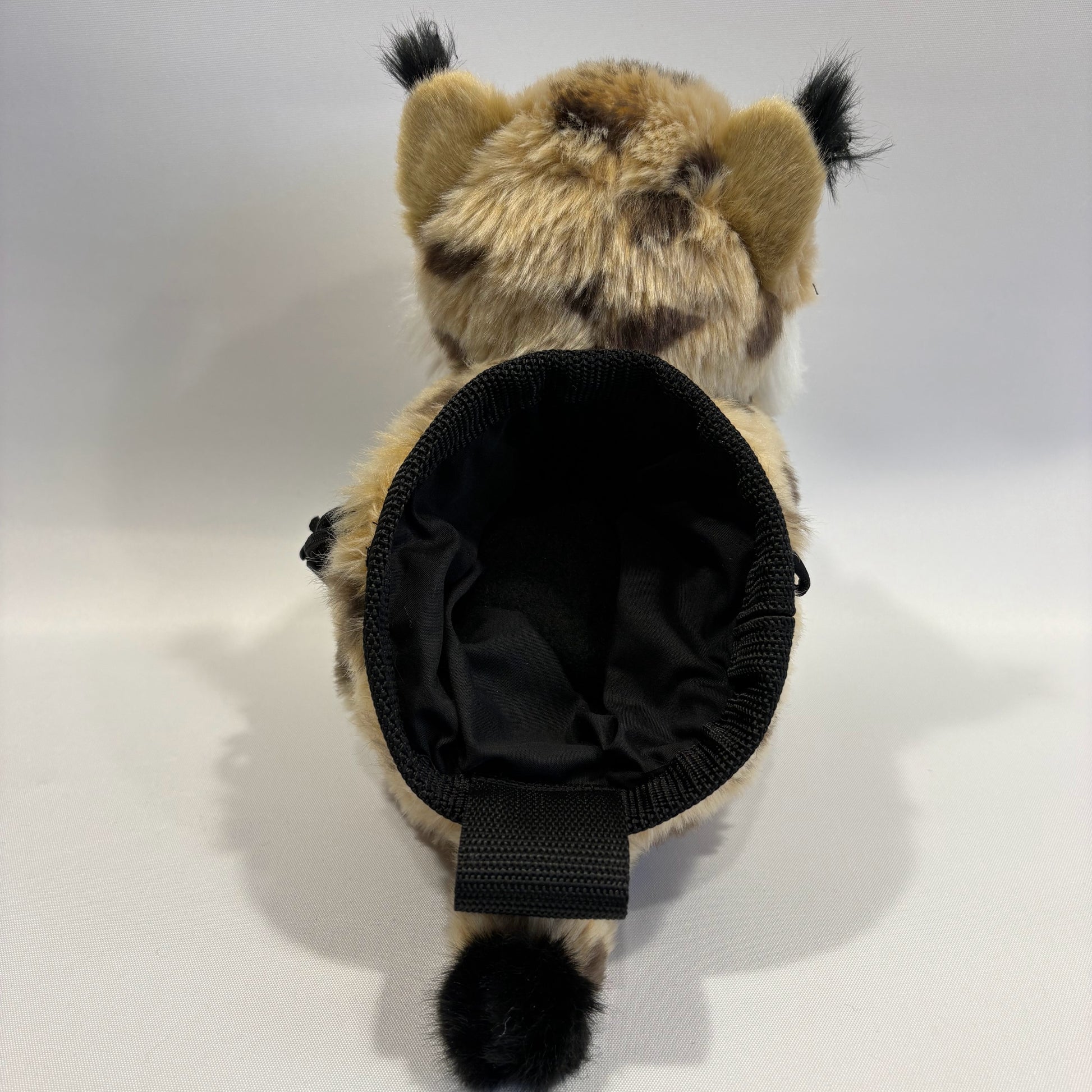 Bobcat plush rock climbing chalk bag rear view showing chalk bag section. Unique climbing gear for kids and women. Background is white