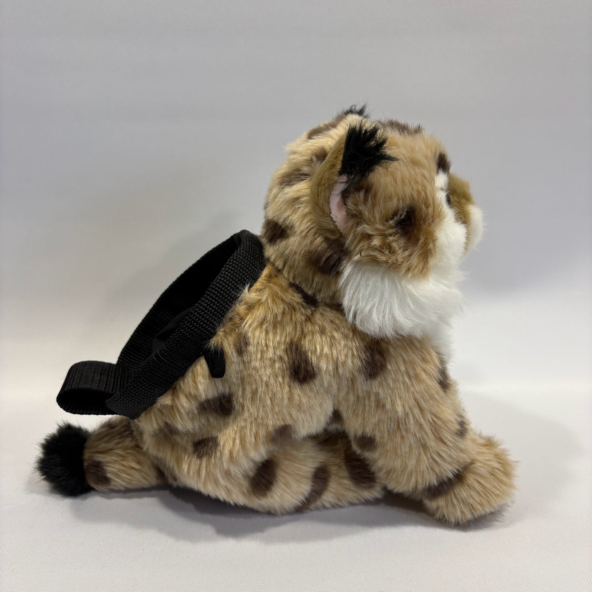 Bobcat plush rock climbing chalk bag seen side on. Unique climbing gear for kids and women. Background is white