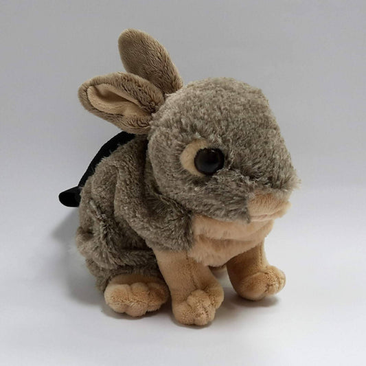 A plush toy rabbit converted into a chalk bag, featuring soft brown and beige fur, upright ears, and a black webbing strap on its back, set against a plain white background.